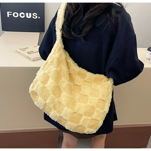 Detail of yellow checkerboard plush tote bag showing soft lamb-wool texture and large capacity