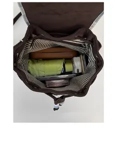 Spacious interior of dark brown velvet backpack with striped lining and drawstring closure