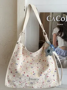 Floral print canvas tote bag in cream with colorful flower patterns and blue charm