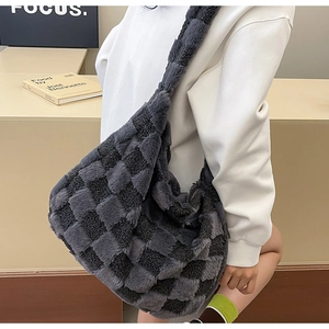 Close-up of dark grey plush checkerboard hobo bag with soft faux fur texture and wide strap
