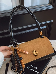 Retro patchwork handbag in brown suede and black leather with gold clasp and wooden beads