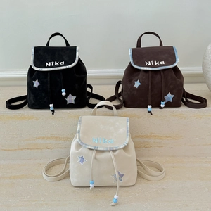Three mini velvet backpacks in black brown and beige colors with star patches