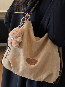 Brown suede tote bag with plush bear charm and Banalu logo for retro streetwear style