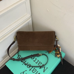 Brown suede baguette bag with bohemian wooden bead charms and long leather strap