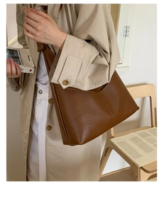 Brown vintage faux leather tote bag showing large capacity and lychee texture