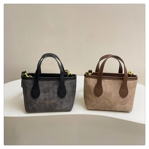 Detail of mini tote bags in dark grey and beige with gold Fashion & BAG logo engraving