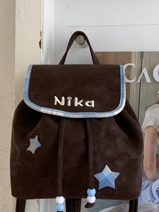 Brown vintage suede backpack with star patches and blue-white checkered trim details
