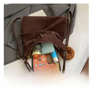 Top view of large brown suede bucket bag showing spacious interior with daily essentials