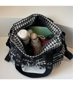 Detail showing high-capacity interior of punk style checkered tote bag with daily essentials