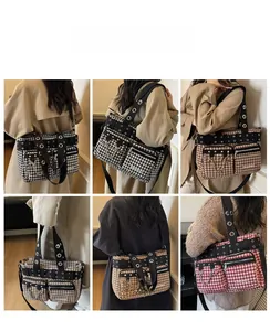 Detail view of houndstooth shoulder bag featuring large metal rings and multi-pocket design