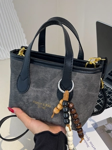 Chic grey denim mini bucket bag with black leather trim and beaded charm for women