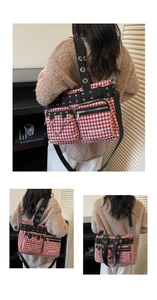 Macro shot of punk style tote bag showing houndstooth fabric, metal eyelets and chains