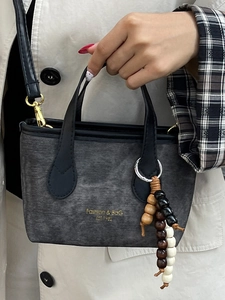 Retro dark grey textured bucket bag with wood bead charm and fashion logo print