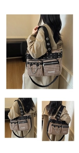Close-up of the large houndstooth tote bag featuring punk rivets and chain details