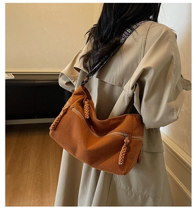 Detail of caramel corduroy shoulder bag with ethnic embroidery wide strap and zip pockets