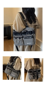 Detailed macro view of large houndstooth crossbody bag with silver rivets and zippers