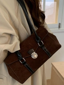 Retro dark brown suede shoulder bag with black leather straps and silver buckle detail