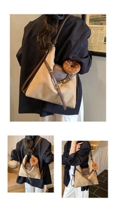 Detail of brown suede tote bag with leather straps and chocolate donut pendant