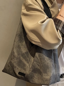 Large gray faux suede tote bag with distressed marble texture and wide shoulder strap