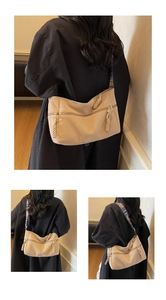 Detailed view of beige corduroy tote bag featuring colorful ethnic woven shoulder strap
