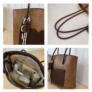 Detail of the woven brown tote bag showing its spacious interior and chocolate charm