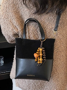 Retro black leather handbag with velvet stitching and bohemian beaded pendant charm