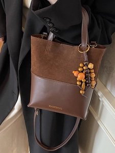 Brown vintage handbag with suede leather patchwork and decorative wooden beads