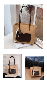Macro shot of brown woven tote bag featuring dark leather pocket and chocolate charm