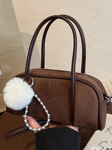 Deep brown faux suede bowling bag with white pompom and pearl chain accessories