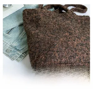 Detail view of deep brown faux shearling tote bag with rich wool texture and soft handles