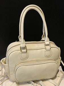 Creamy white vintage Boston handbag with dual zippers and a detachable shoulder strap
