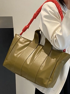 Olive green tote bag with red braided strap for commuting and travel for women