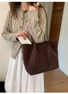 Detail showing deep brown suede tote bag capacity with a smartphone for size reference