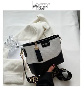 Detail of the embossed checkered pattern on the white and black leather bucket bag