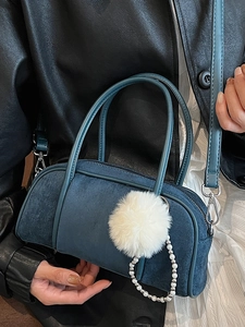 Dark blue faux suede bowling bag with fluffy pompom and elegant pearl chain accessory
