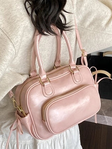 Pink glossy Boston handbag with bow detail and gold hardware for women's fashion