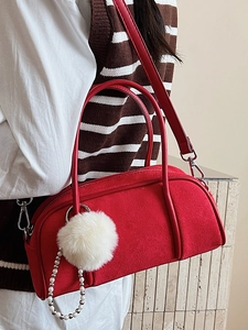 Elegant red suede bowling bag with fluffy pompom and adjustable shoulder strap for women