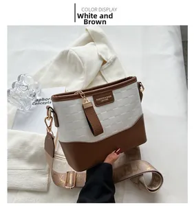 Detailed shot of checkered embossed texture and leather logo on white and brown bag
