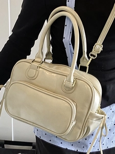 Chic beige Boston style leather handbag with golden hardware and adjustable strap