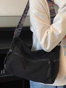 Large black corduroy tote bag with colorful ethnic patterned shoulder strap for women