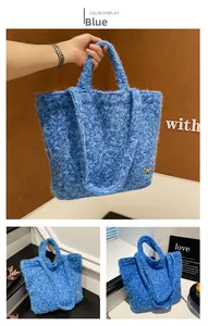 Detailed macro of plush blue tote bag texture with heart emblem and stylish handles
