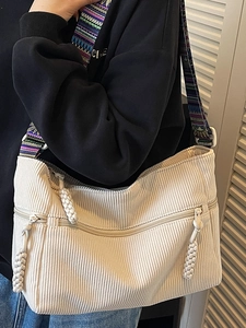 White corduroy tote bag with ethnic style floral strap and dual zipper pockets