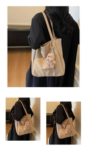 Close-up of soft apricot suede tote bag with cute plush bear and pearl chain detail