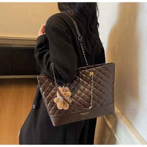 Quilted tote bag in chocolate brown with gold chain strap and plush bear charm