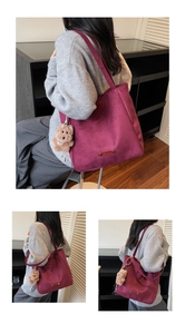 Deep burgundy suede tote bag featuring a cute brown teddy bear charm and brown leather tag