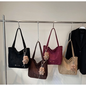 Selection of four vintage faux suede tote bags in various colors with teddy bear charms