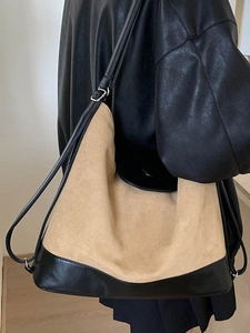 Minimalist khaki matte suede tote bag with black leather base and long shoulder strap