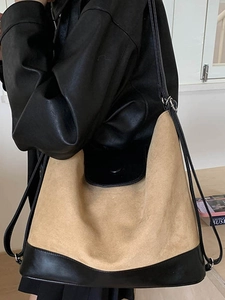 Minimalist large-capacity beige and black patchwork tote bag worn by a model
