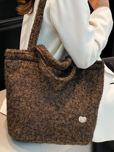 Deep brown bouclé fleece tote bag with silver heart charm for winter commuting