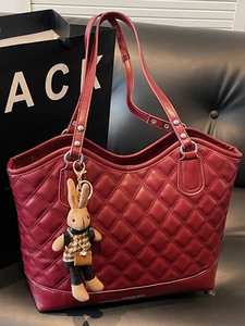 Red quilted leather tote bag with rabbit charm and stylish diamond stitching for women